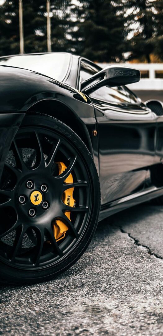 A close up of the wheel on a black car